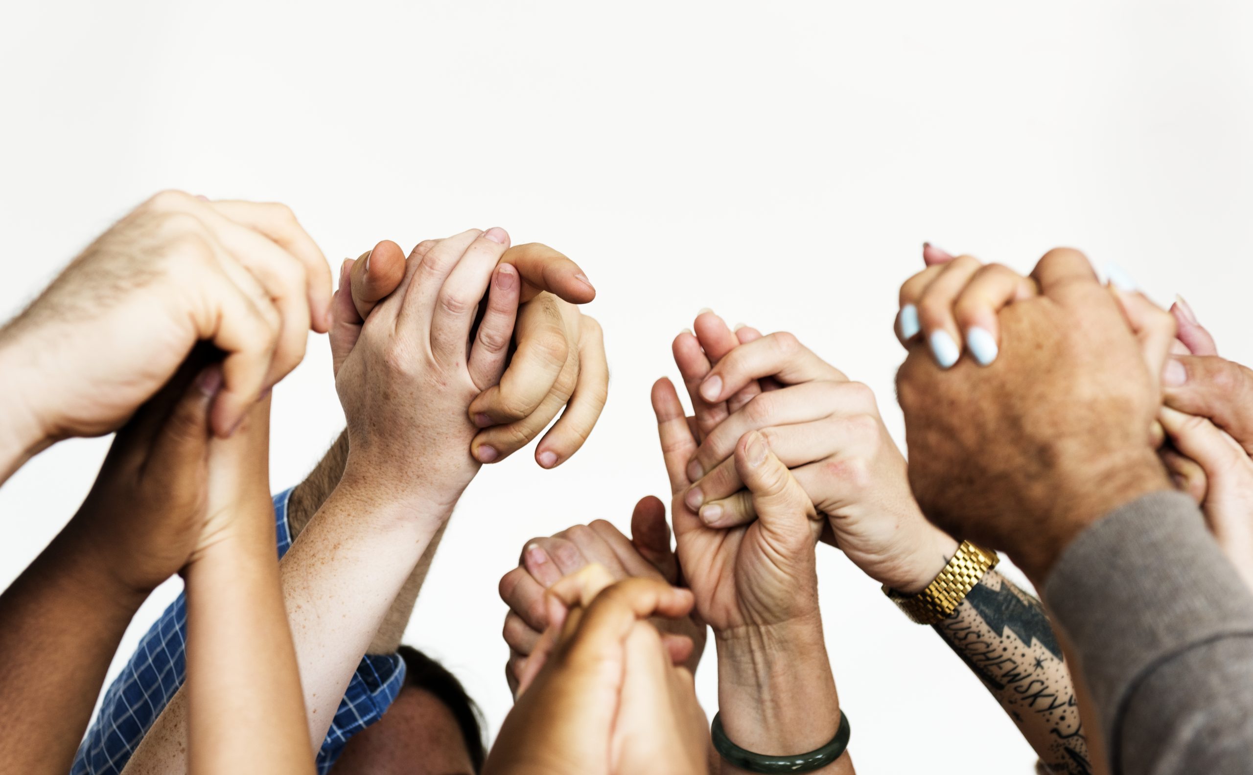 Closeup of diverse people holding hands